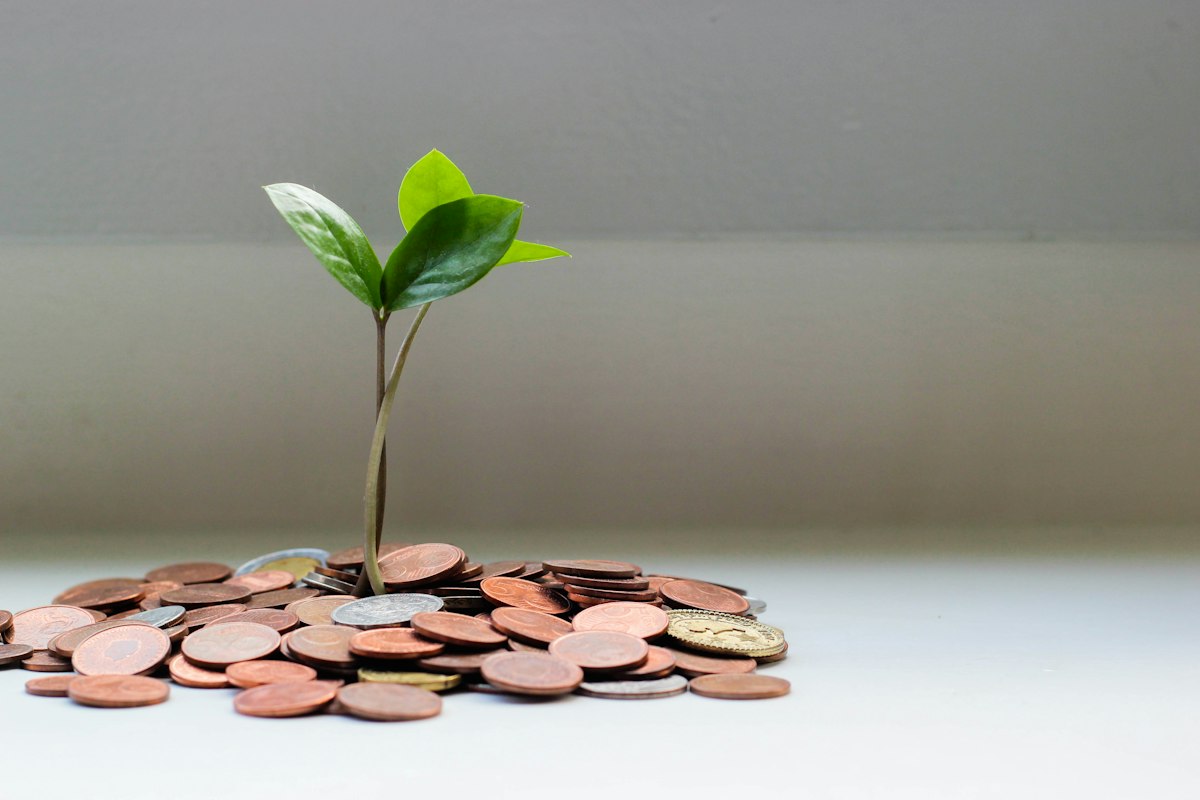 Coins in a glass jar illustrating a starter emergency savings fund